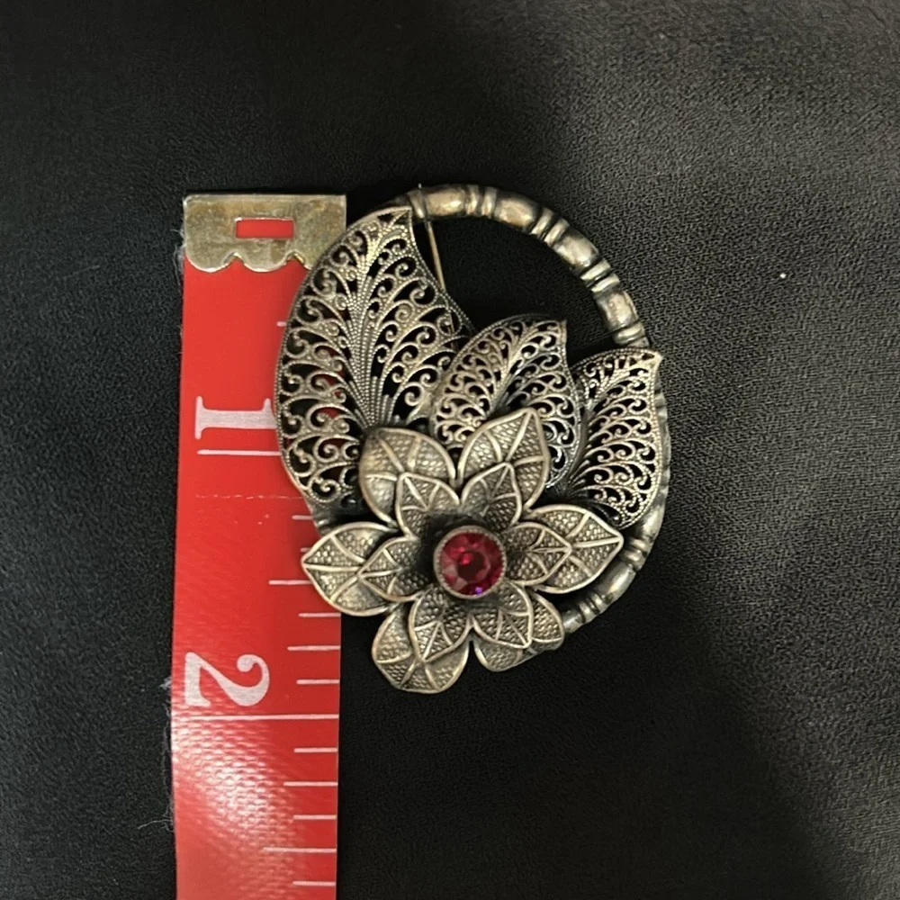 Elegant Silver Floral Brooch with Red Accent